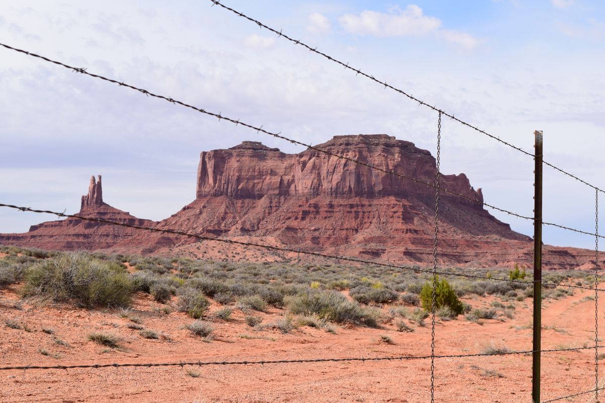 Sandstone buttes rising from the desert floor at Monument Valley
